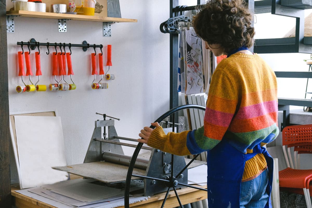A heat press being used in a small t-shirt printing workspace