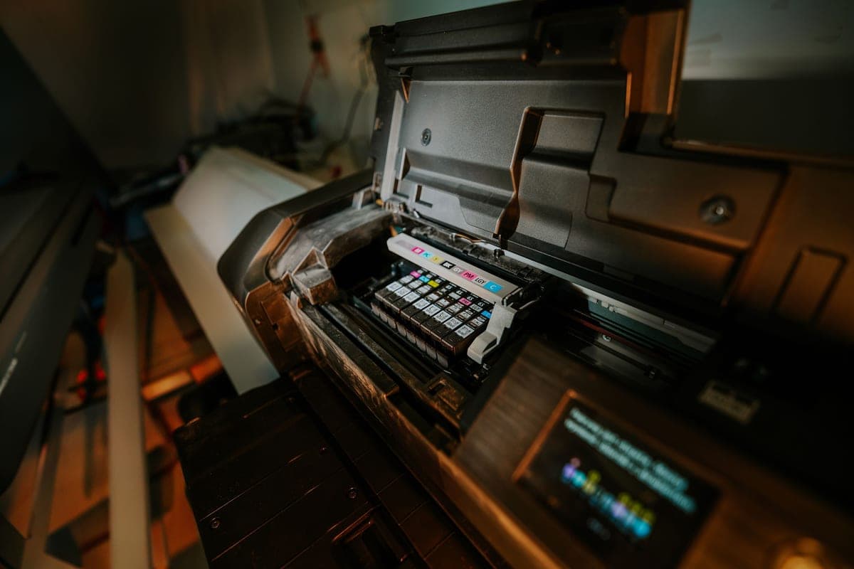 A printer and sublimation supplies on a work surface