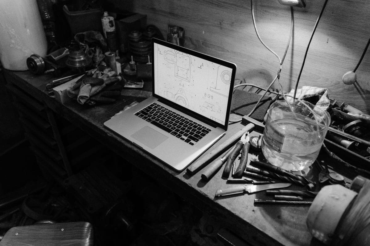 A desktop fabrication machine on a workshop bench