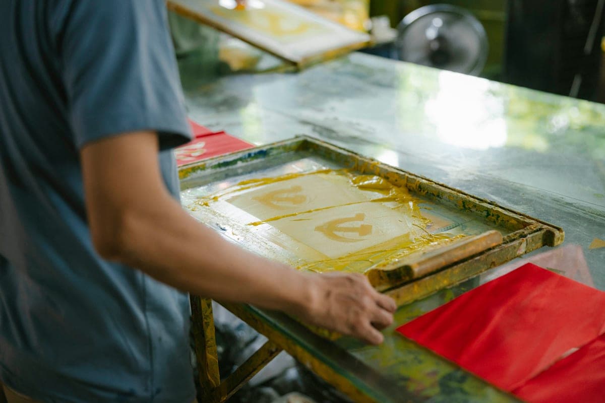 A heat press in a small t-shirt printing workspace