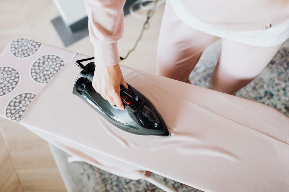 A heat source being pressed onto fabric on a padded surface