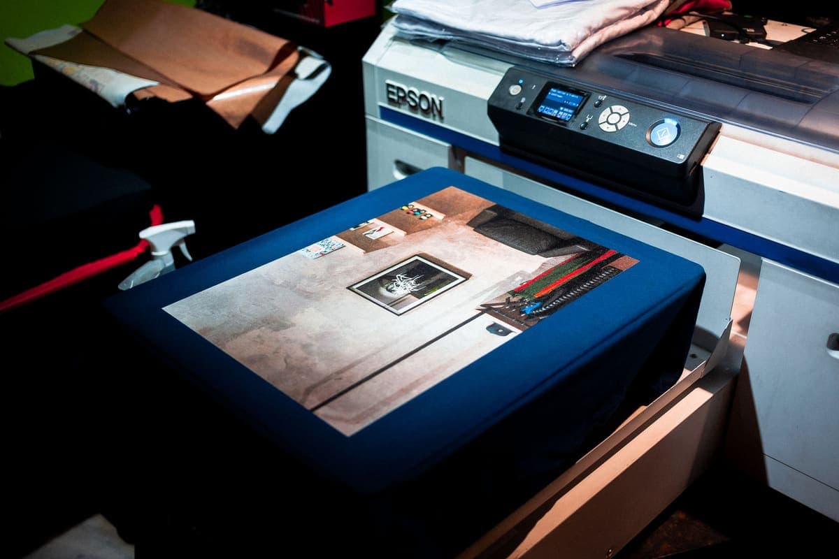 A printer producing a custom design onto fabric in a studio