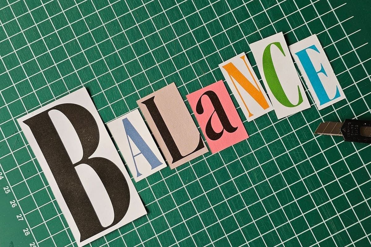 Cut-out letters arranged on a green cutting mat