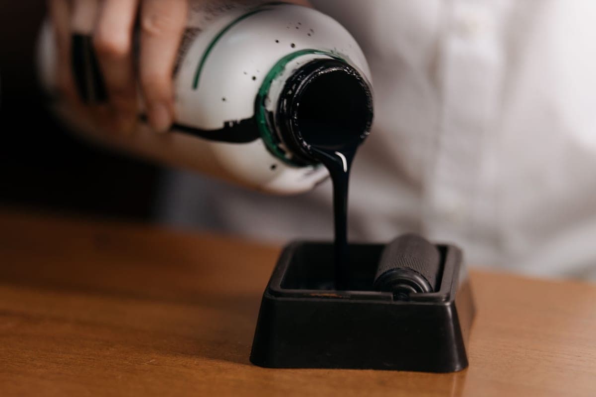 Printer ink refill bottles on a work surface