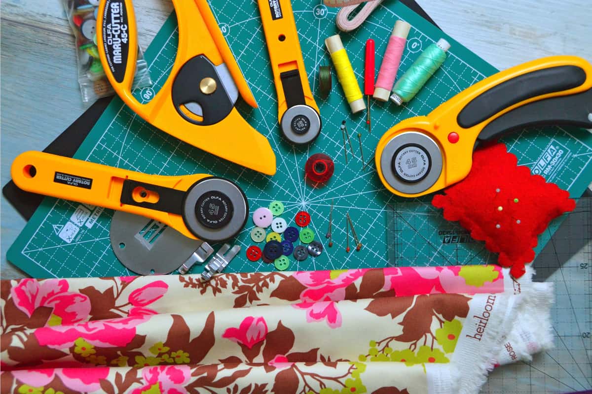 A self-healing cutting mat and craft supplies on a work surface
