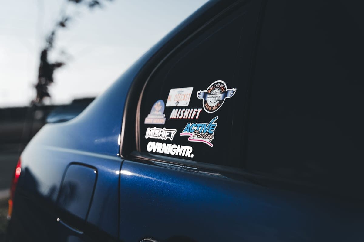 A vinyl decal being applied to a car window
